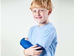 Boy holding arm in cast