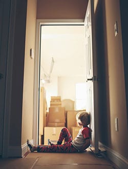 Schreier & Housewirth Family Law in Fort Worth, TX - Image of Sad Child and Moving Boxes