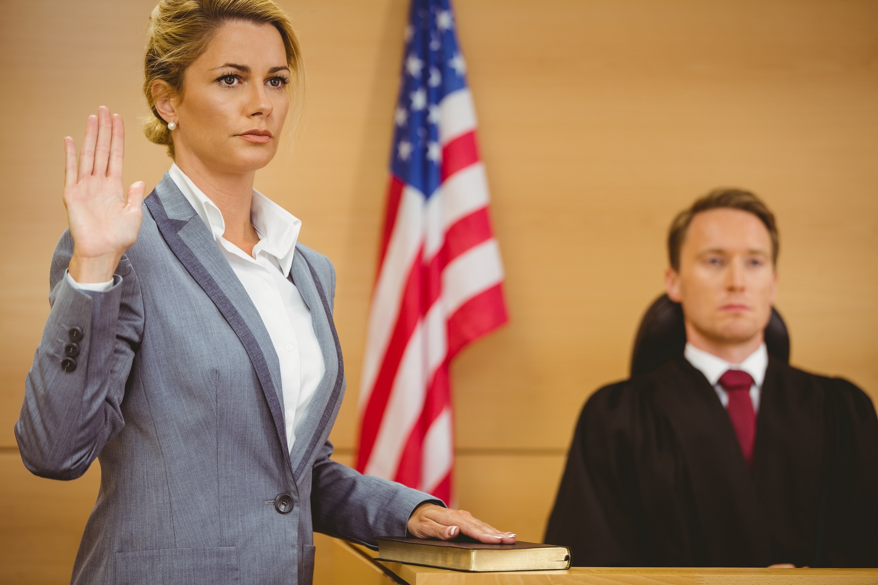 Witness in divorce trial swearing their oath